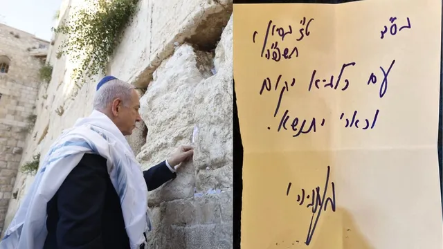 Prime Minister Netanyahu saying a prayer at the Western Wall.
